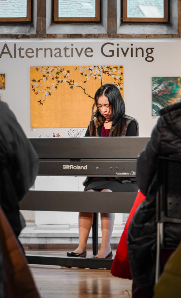 Reese Carly Manglicmot playing the piano in West Kilbride