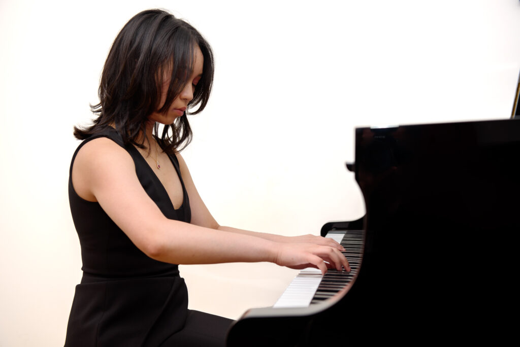 Reese Carly Manglicmot playing the piano